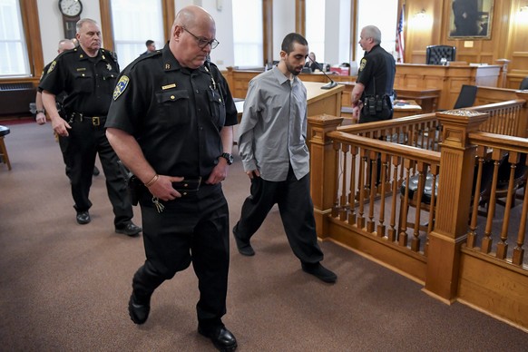 Hadi Matar, second from right, is led out of Chautauqua County court after the guilty verdict in the August 2022 knife attack of author Salman Rushdie in Mayville, N.Y., Friday, Feb. 21, 2025. (AP Pho ...