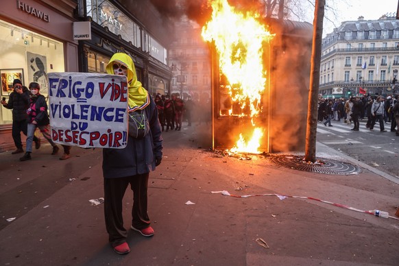 epa10539317 A protester holds a placard &#039;empty fridge = violence of despair&#039; during a demonstration against the government pension reform in Paris, France, 23 March 2023. Protests continue i ...