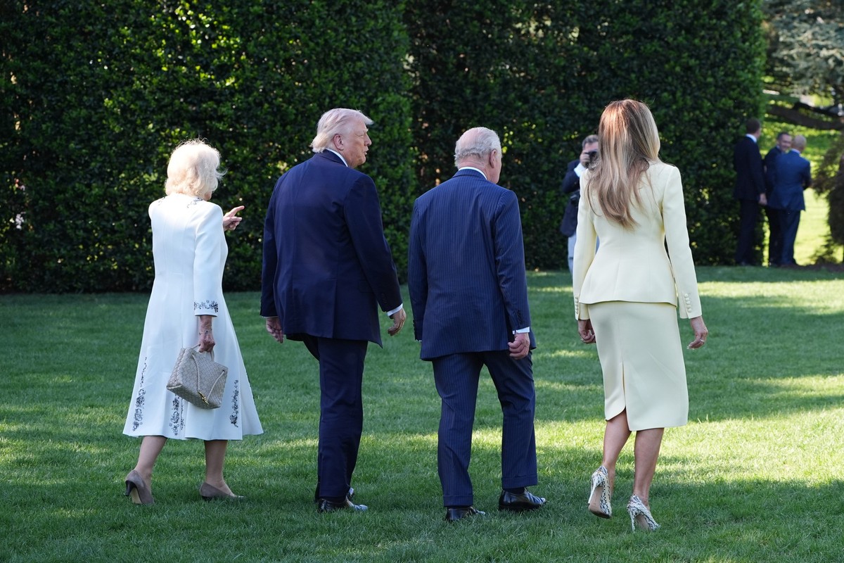 President Donald Trump and first lady Melania Trump along with Britain's King Charles III and Queen Camilla walk on the South Lawn after looking at the White House garden and bee hive at the Whit ...
