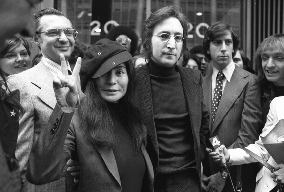 FILE - In this April 18, 1972 file photo, John Lennon and his wife, Yoko Ono, leave a U.S. Immigration hearing in New York City. Mark David Chapman, who shot and killed Lennon on Dec. 8, 1980, was den ...