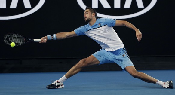 Croatia&#039;s Marin Cilic reaches for a forehand return to Australia&#039;s Bernard Tomic during their first round match at the Australian Open tennis championships in Melbourne, Australia, Monday, J ...