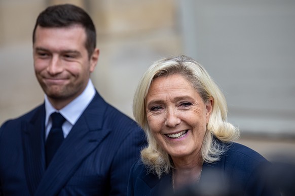 epa12345227 French leaders of the far-right party ?Rassemblement National,? Jordan Bardella (L) and Marine Le Pen (R), speak to media at the Hotel Matignon after a meeting with the French prime minist ...