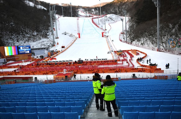 epa06513017 A general view of police standing amongst empty seats in a spectator area of the Men&#039;s Downhill race at the Jeongseon Alpine Centre during the PyeongChang 2018 Olympic Games, South Ko ...