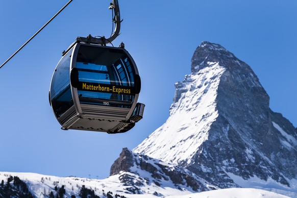 FILE - A &#039;Matterhorn-Express&#039; gondola lift in front of Matterhorn mountain in the Zermatt ski resort, in Zermatt, Switzerland, March 18, 2020. Skiing���s newest downhill course that crosses  ...