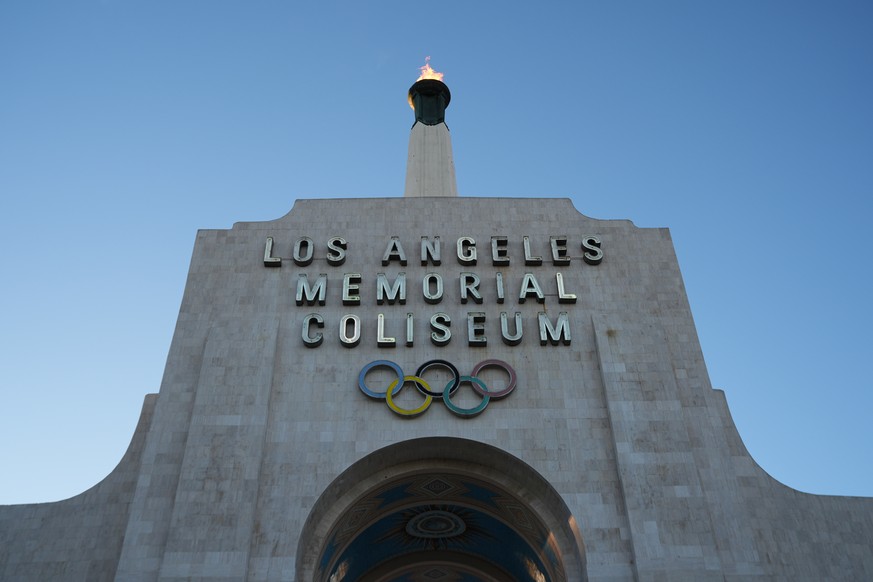 The Olympic cauldron is lit at the Los Angeles Memorial Coliseum ahead of the launch for ticket registration to the 2028 Summer Olympic Games Tuesday, Jan. 13, 2026, in Los Angeles. (AP Photo/Damian D ...