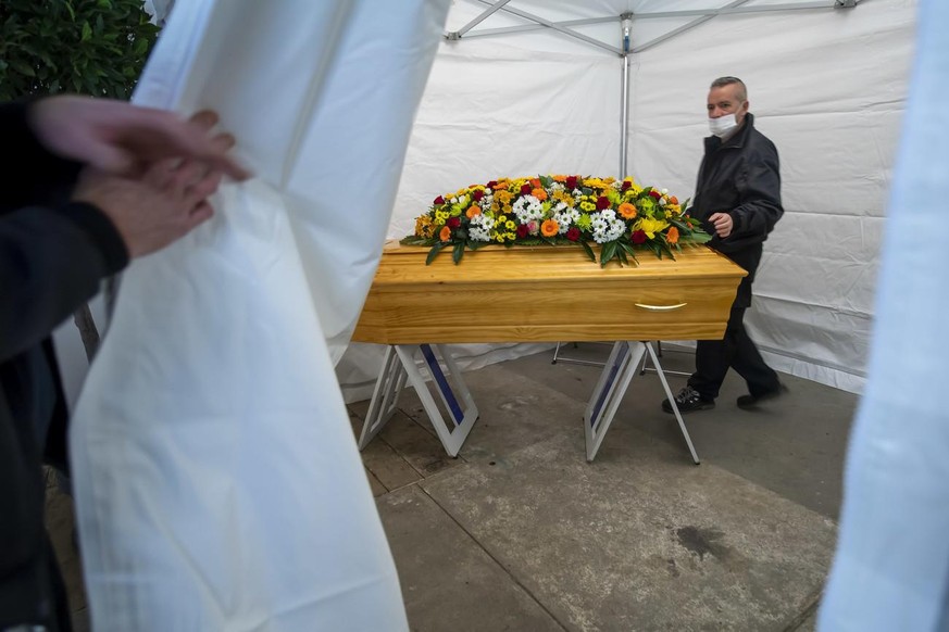 Des employes des pompes funebres preparent un cercueil sous une tente qui fera office de chambre funeraire provisoire, installee dans un entrepot afin que les familles puisse ce recueillir dans l&#039 ...