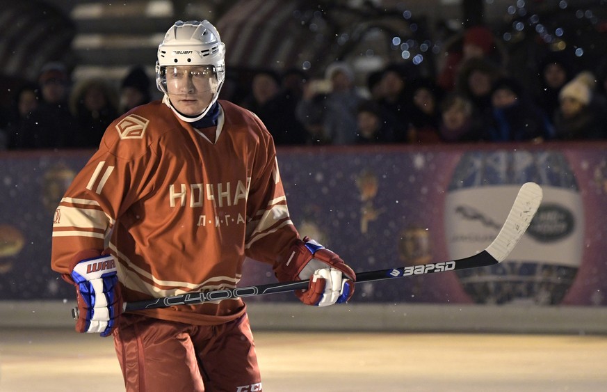 In this photo taken on Saturday, Dec. 23, 2017, Russian President Vladimir Putin takes part in a match of the Night Hockey League skating rink next to at GUM Department store in Red Square in Moscow,  ...