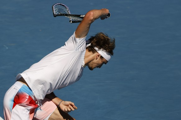 Alexander Zverev of Germany smashes his racket in frustration during his fourth round match against Denis Shapovalov of Canada at the Australian Open tennis championships in Melbourne, Australia, Sund ...