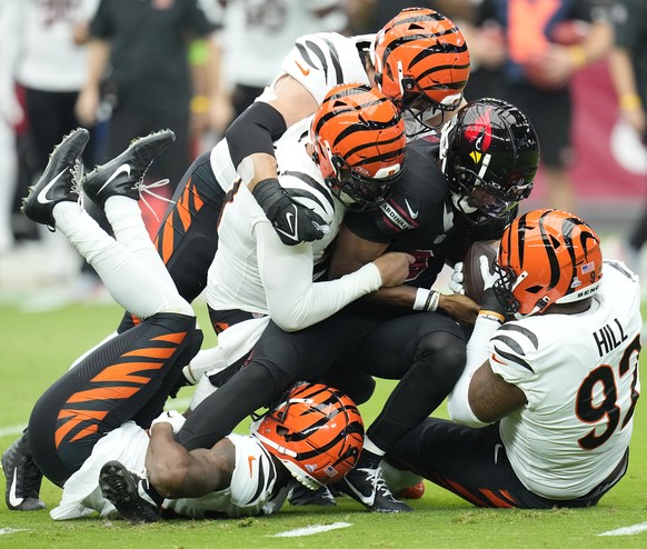 Arizona Cardinals quarterback Joshua Dobbs, center, is sacked by Cincinnati Bengals defensive end Jeff Gunter (93) during an NFL football game, Sunday, Oct. 8, 2023, in Glendale, Ariz. (AP Photo/Ross  ...