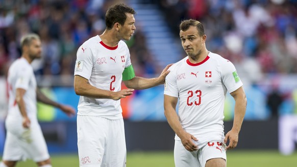 Switzerland's defender Stephan Lichtsteiner, left, talks with Switzerland's midfielder Xherdan Shaqiri, right, during the FIFA World Cup 2018 group E preliminary round soccer match between S ...