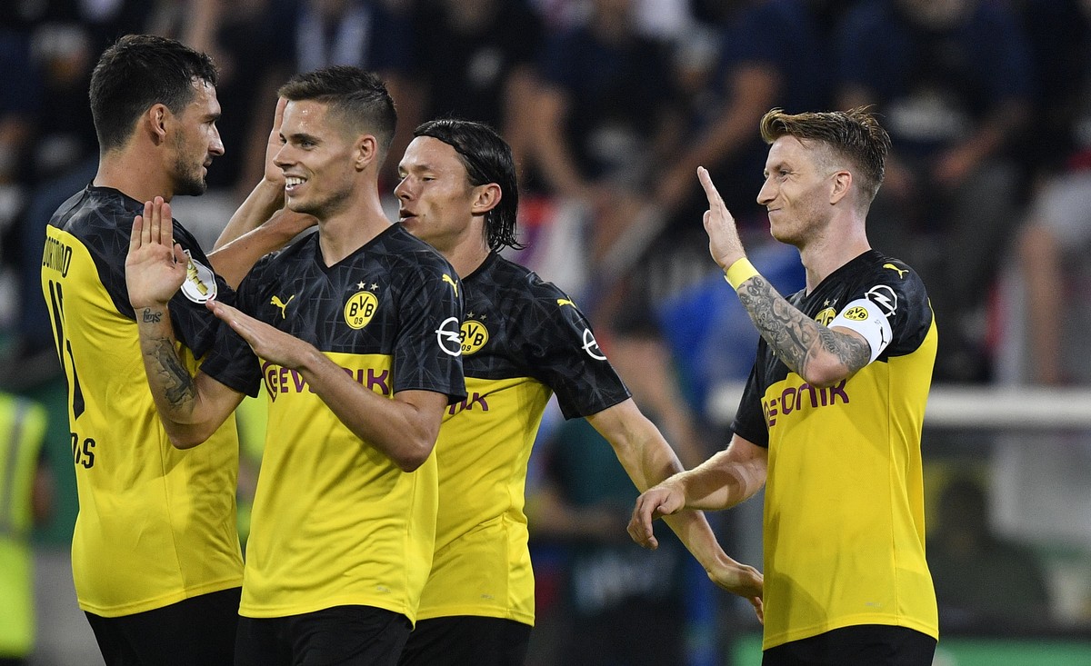 Dortmund's Marco Reus, right, celebrates his opening goal with teammate Mats Hummels, left, during the German soccer cup, DFB Pokal, first Round match between KFC Uerdingen 05 and Borussia Dortmu ...
