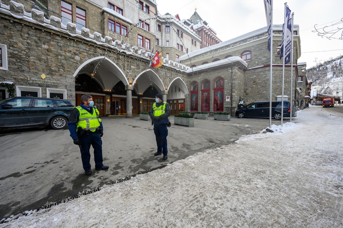 epa08946372 Policemen stand guard outside Badrutt's Palace Hotel on Via Serlas in St. Moritz, Switzerland, 18 January 2021. Guests and employees at the Grand Hotel des Bains Kempinski St Moritz a ...