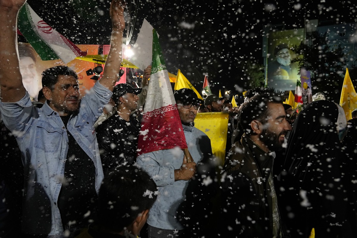 Demonstrators cheer as artificial snow sprayed in an anti-Israeli gathering celebrating Iran's missile strike against Israel, at Felestin (Palestine) Sq. in Tehran, Iran, Tuesday, Oct. 1, 2024. ( ...