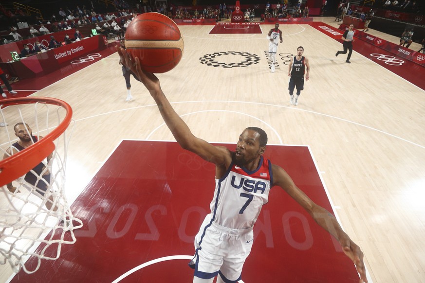 USA's Kevin Durant (7) drives to the basket during the men's basketball gold medal game against France at the 2020 Summer Olympics, Saturday, Aug. 7, 2021, in Saitama, Japan.  (Gregio...