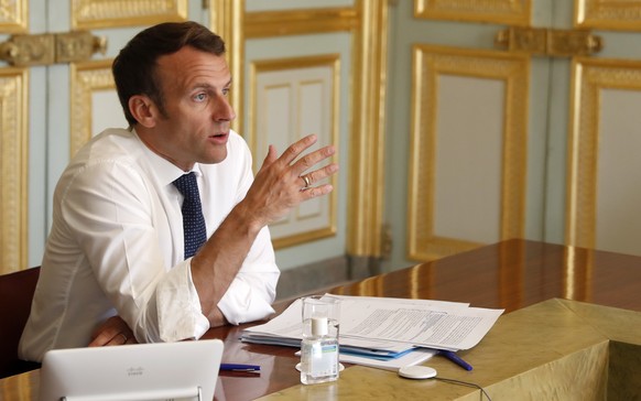 epa08366731 French President Emmanuel Macron attends a video conference call with French virologist and President of the Research and Expertise Analysis Committee (Comite Analyse Recherche et Expertis ...