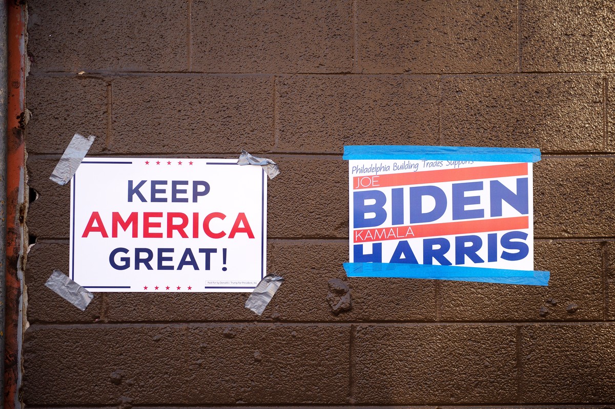 epa08795281 Signs abound as voters wait in line at the Guerin Recreation Center polling station in Philadelphia, Pennsylvania, USA, 03 November 2020. Americans vote on Election Day to choose between r ...