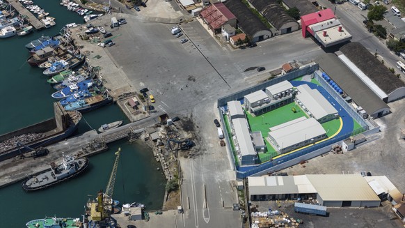 A migrant center, right, is seen from above in the port of Shengjin, northwest Albania, Thursday, July 25, 2024. Migrants rescued at sea while attempting to reach Italy are likely to see themselves tr ...