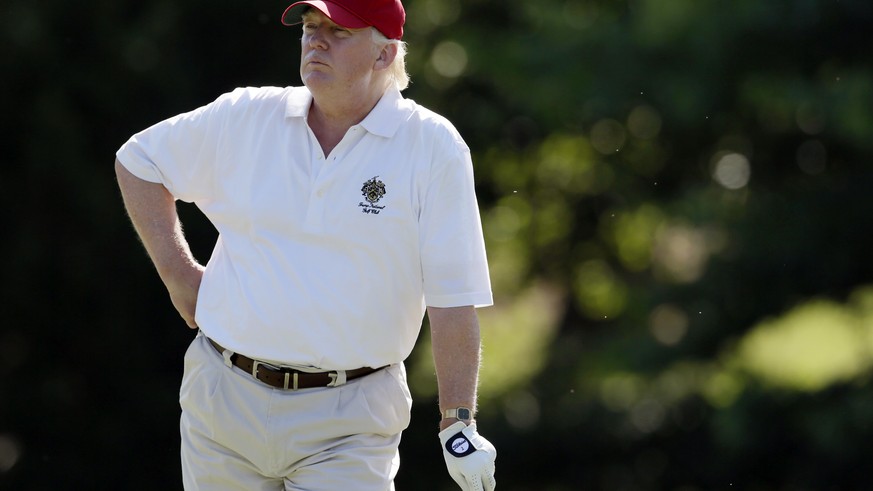 FILE - In this June 27, 2012, file photo, Donald Trump stands on the 14th fairway during a pro-am round of the AT&amp;T National golf tournament at Congressional Country Club in Bethesda, Md. Donald T ...