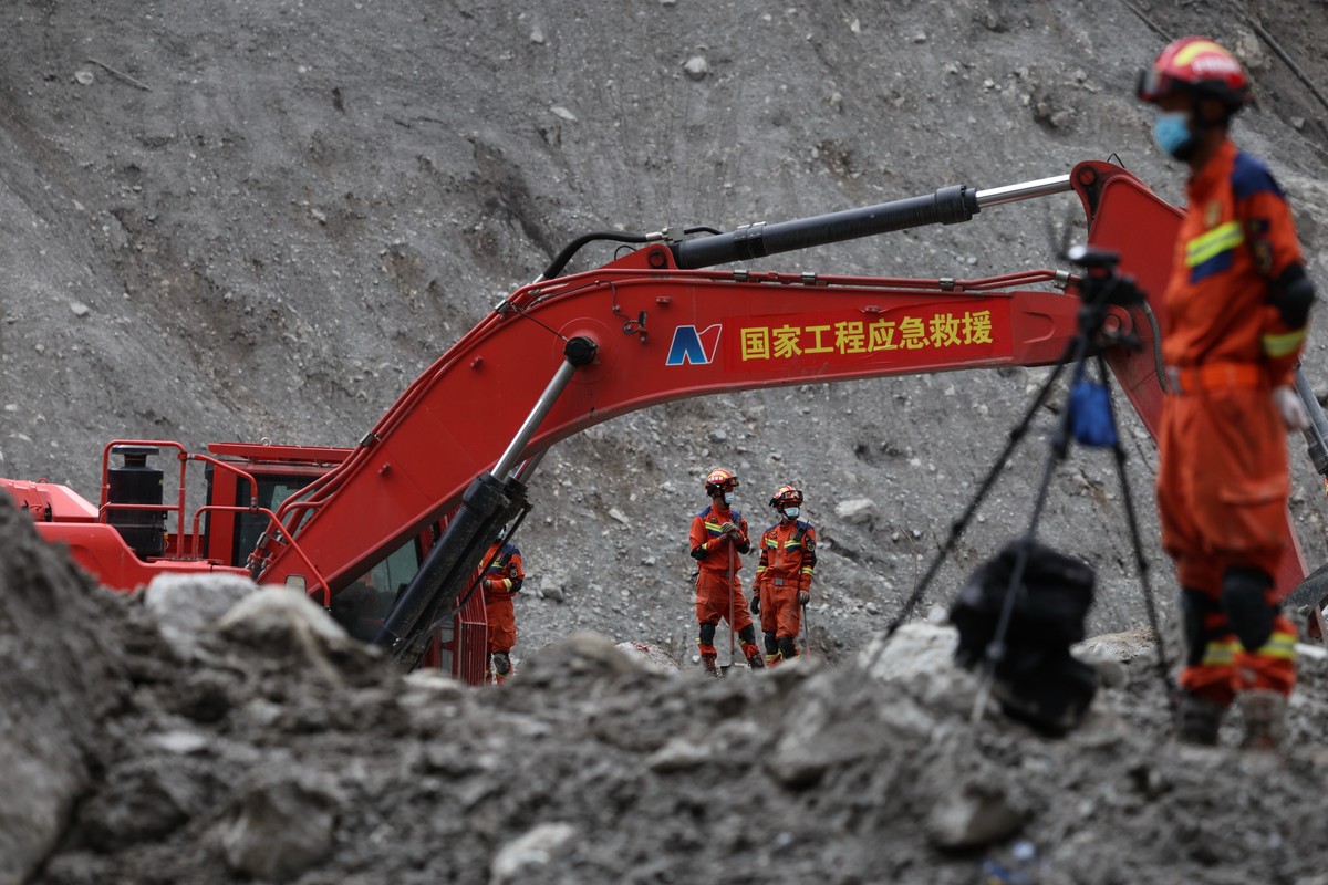 Rescue workers conduct search-and-rescue operations at the core disaster-hit area at Gyirong Port following the August 26 mudslide, during an organized media tour in Shigatse, Tibet Autonomous Region, ...