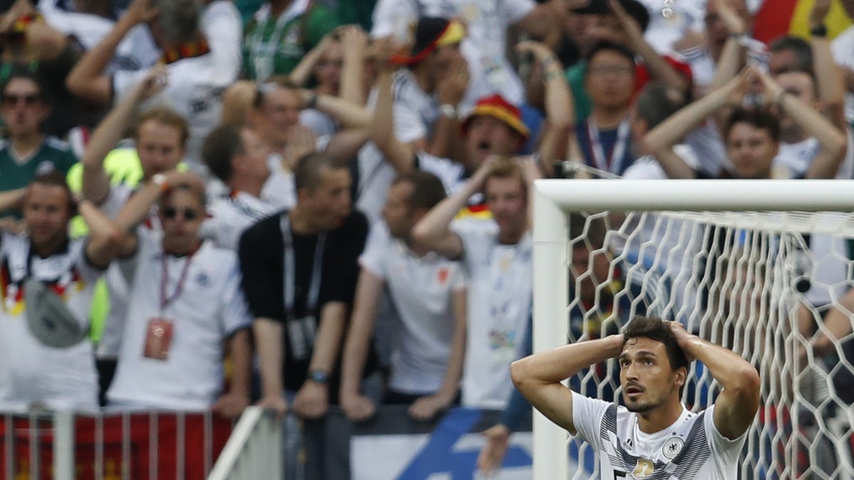 Germany's Mats Hummels reacts along with Germany fans after Germany's loss to Mexico in their group F match at the 2018 soccer World Cup in the Luzhniki Stadium in Moscow, Russia, Sunday, Ju ...