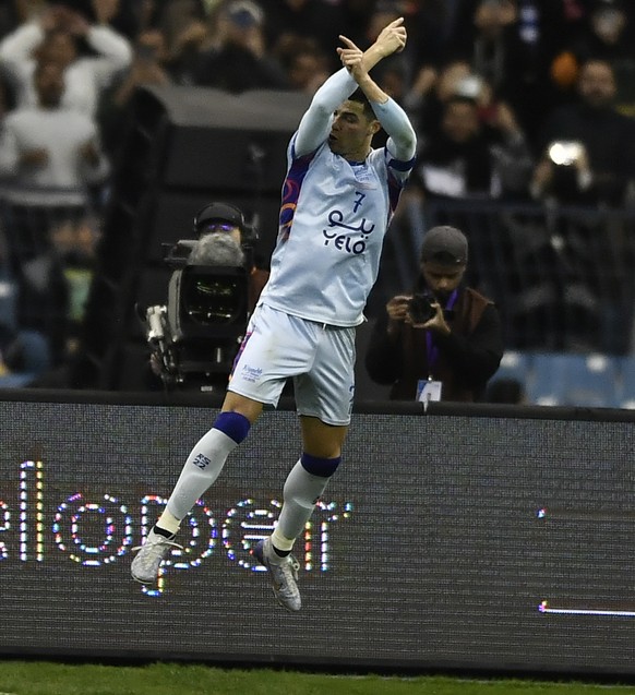 epa10416291 Cristiano Ronaldo of Riyadh XI celebrates after scoring the 1-1 goal during the friendly soccer match between the Riyadh XI and Paris Saint-Germain, in Riyadh, Saudi Arabia, 19 January 202 ...