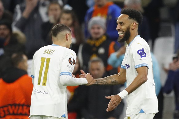 epa11205361 Pierre-Emerick Aubameyang (R) of Olympique Marseille celebrates scoring the 4-0 goal with teammate Amine Harit (L) during the UEFA Europa League Round of 16 first leg soccer match between  ...