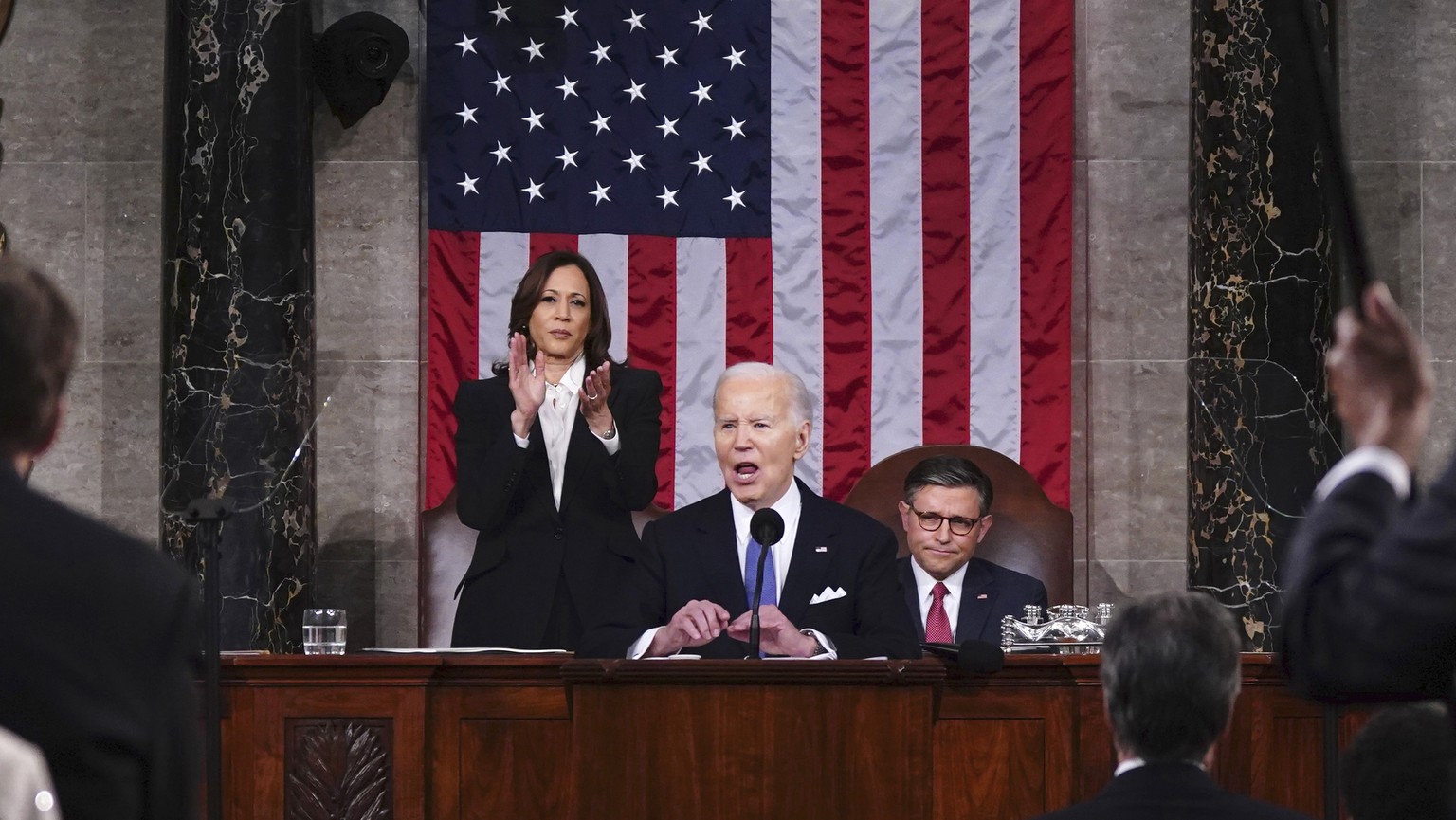 President Joe Biden delivers the State of the Union address to a joint session of Congress at the Capitol, Thursday, March 7, 2024, in Washington. Standing at left is Vice President Kamala Harris and  ...