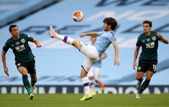 epa08502723 David Silva (C) of Manchester City in action during the English Premier League match between Manchester City and Burnley in Manchester, Britain, 22 June 2020. EPA/Martin Rickett/NMC/Pool E ...