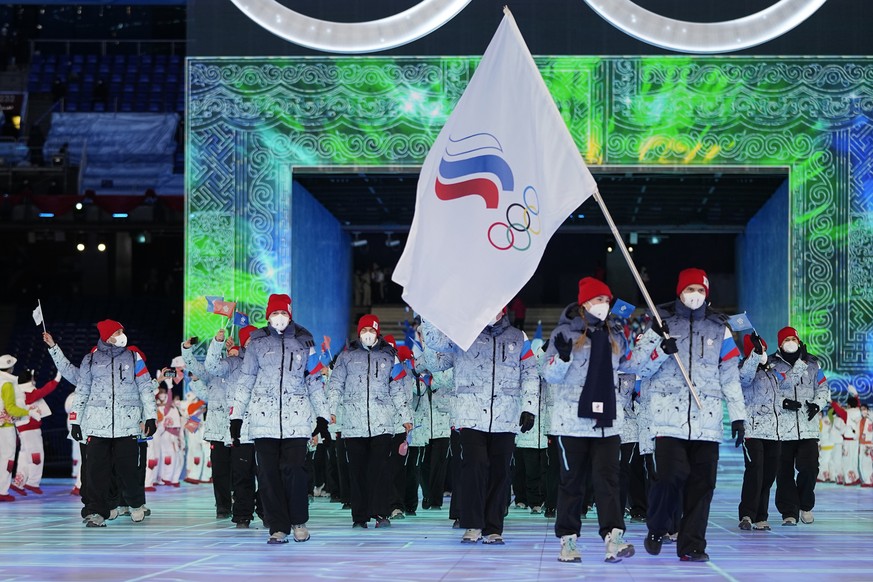 FILE- Olga Fatkulina and Vadim Shipachyov, of the Russian Olympic Committee, carry a flag into the stadium during the opening ceremony of the 2022 Winter Olympics, Friday, Feb. 4, 2022, in Beijing. Ru ...