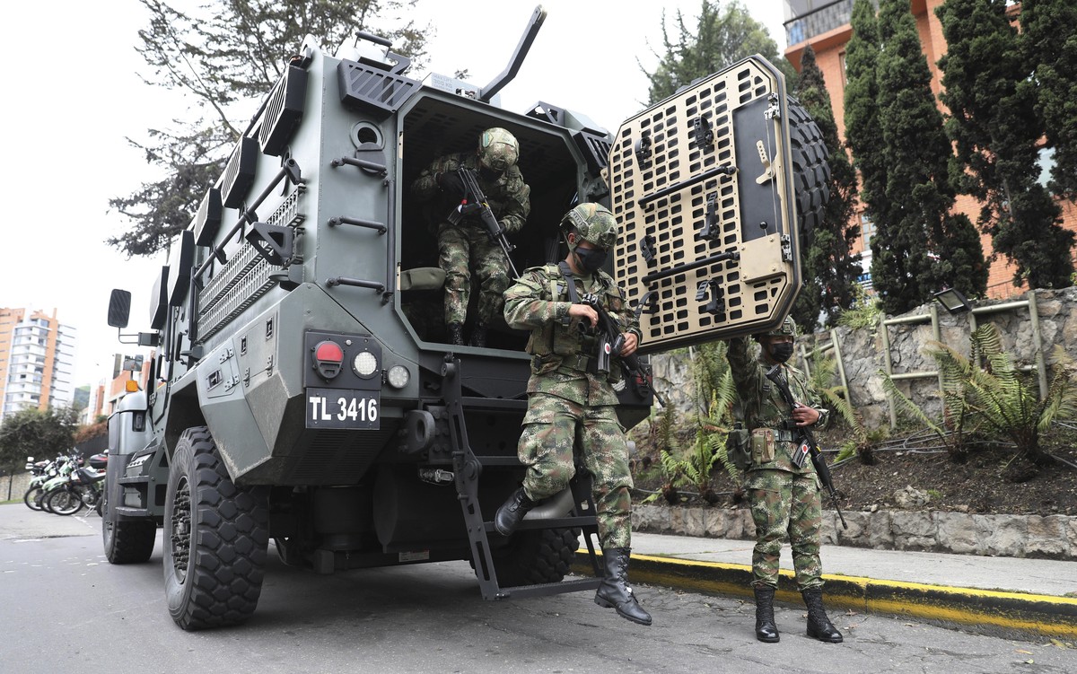 Soldiers exit an armored vehicle during a national strike against tax reform in Bogota, Colombia, Monday, May 3, 2021. Colombia's President Ivan Duque withdrew the government-proposed tax reform  ...