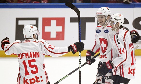 Sven Senteler, centre, of Switzerland celebrates with teammates Gregory Hofmann, left, and Dean Kukan, after scoring during the ice hockey Euro Hockey Tour EHT Karjala Cup match between Czech Republic ...