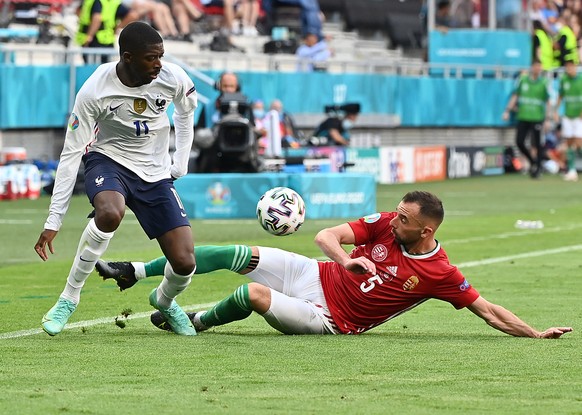 epa09285716 Attila Fiola (R) of Hungary in action against Ousmane Dembele of France during the UEFA EURO 2020 group F preliminary round soccer match between Hungary and France in Budapest, Hungary, 19 ...