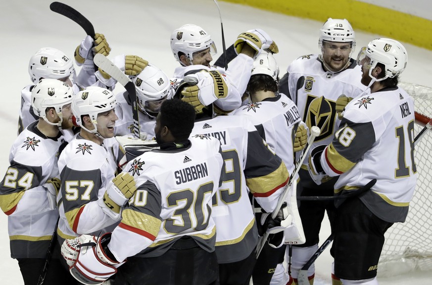 Vegas Golden Knights players hug after a 3-0 win over the San Jose Sharks during Game 6 of an NHL hockey second-round playoff series, Sunday, May 6, 2018, in San Jose, Calif. (AP Photo/Marcio Jose San ...