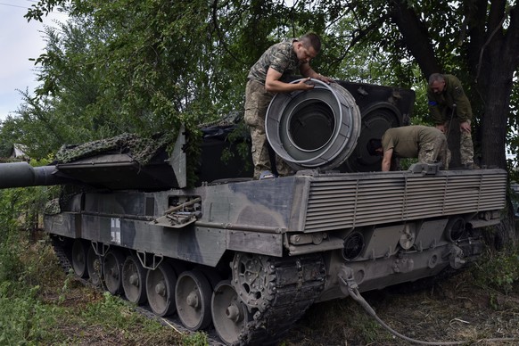 FILE - Ukrainian soldiers repair a Leopard 2 tank in Zaporizhzhya region, Ukraine, on June 21, 2023. When Russia invaded Ukraine in February 2022, Ukraine?s military was largely reliant on Soviet-era  ...