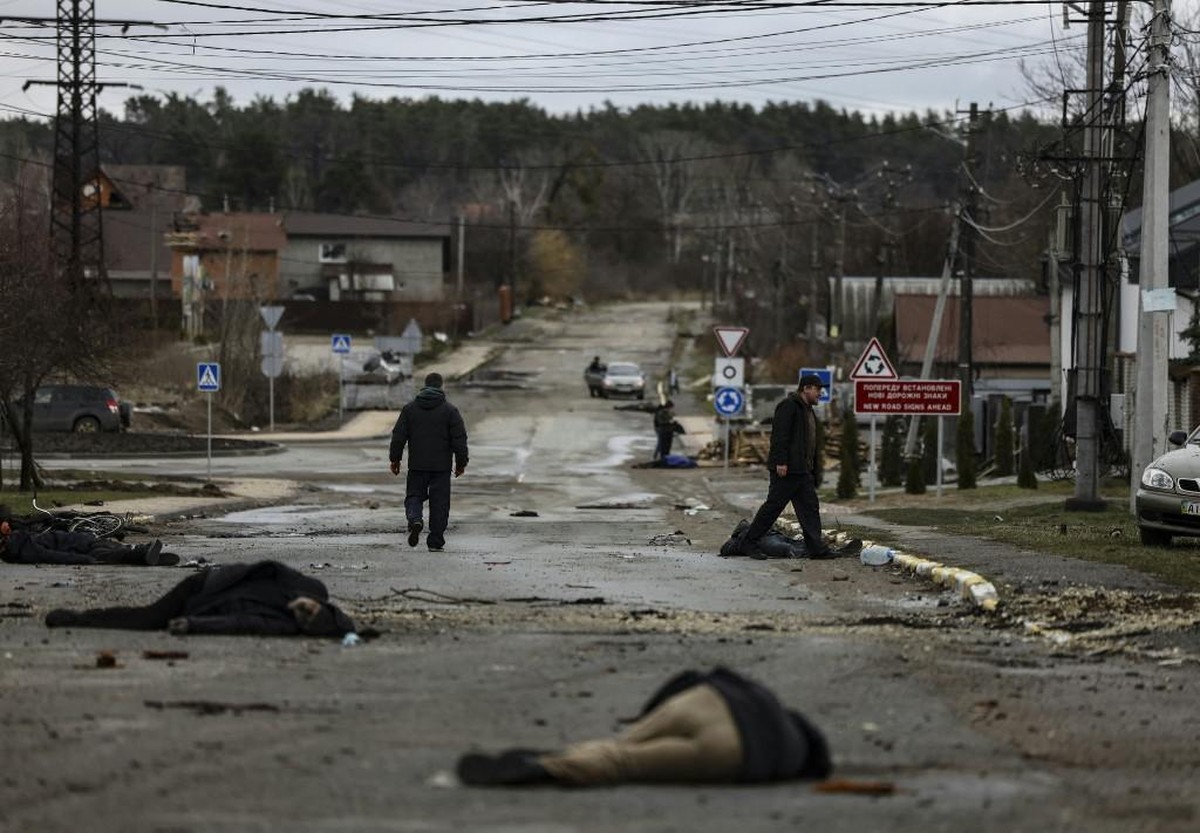 Bodies lie on a street in Bucha, northwest of Kyiv, as Ukraine says Russian forces are making a "rapid retreat" from northern areas around Kyiv and the city of Chernigiv, on April 2, 2022. T ...
