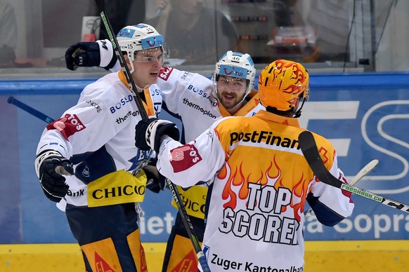 From left Zug&#039;s player Grégory Hofmann celebrates the 3-4 goal with Zug&#039;s player Lino Martschini and Zug&#039;s player Raphael Diaz, during the preliminary round game of National League A (N ...