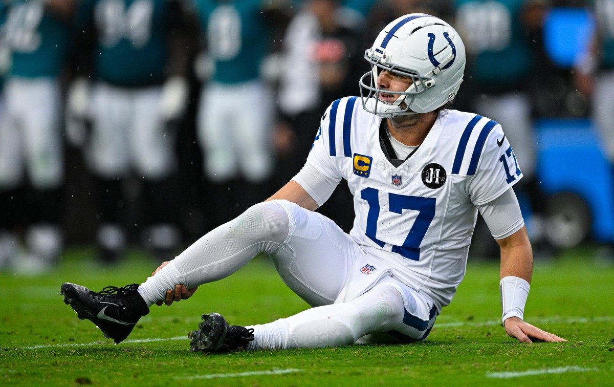 Indianapolis Colts quarterback Daniel Jones (17) grabs his leg after an injury during the first half of an NFL football game against the Jacksonville Jaguars, Sunday, Dec. 7, 2025, in Jacksonville, Fl ...