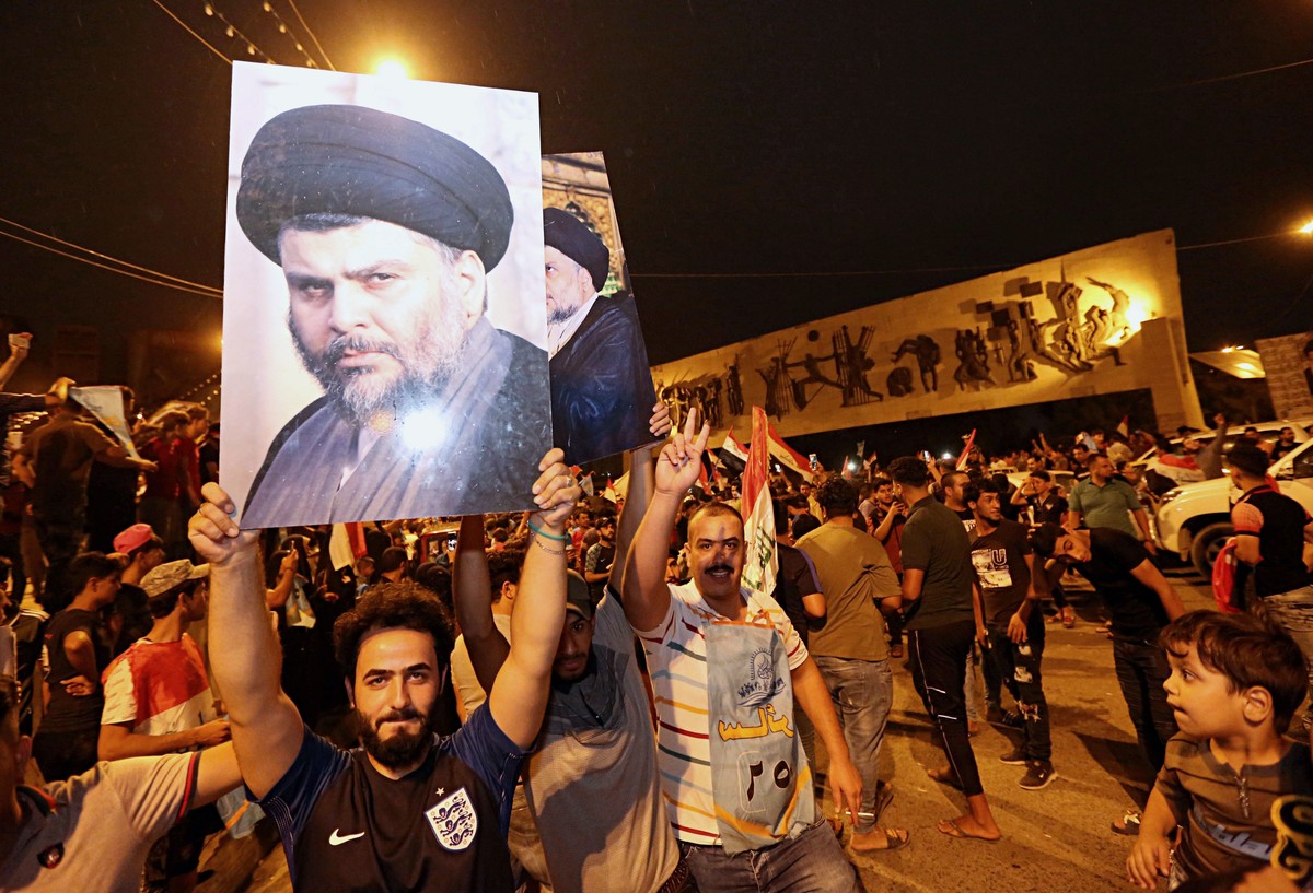 Followers of Shiite cleric Muqtada al-Sadr, seen in the posters, celebrate in Tahrir Square in Baghdad, Iraq, early Monday, May 14, 2018. Iraq's electoral commission announces influential Shiite  ...