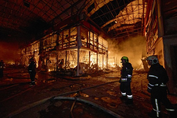 epaselect epa12419266 Ukrainian rescuers work to extinguish a fire at the site of a Russian strike on a marketplace in Kharkiv, northeastern Ukraine, 01 October 2025, amid the Russian invasion. Accord ...