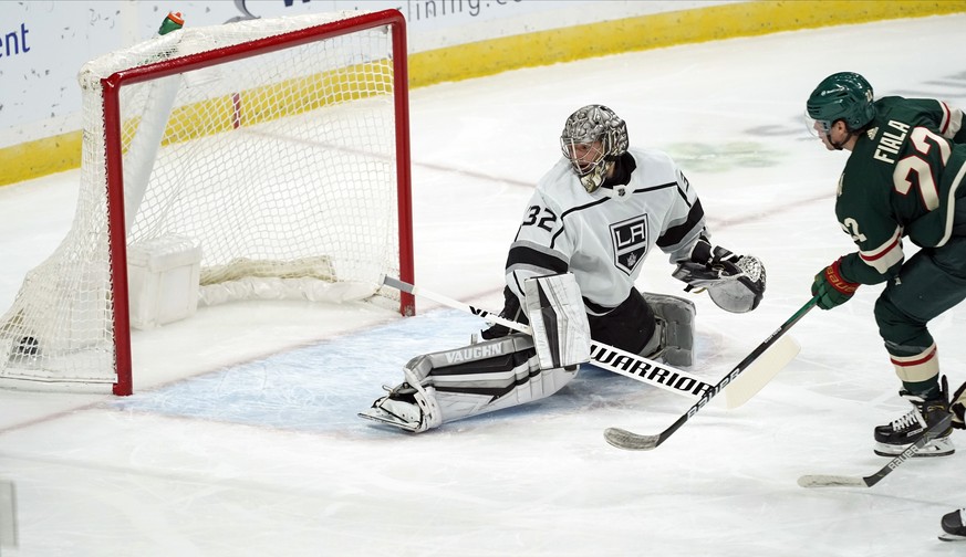 Los Angeles Kings&#039; goalie Jonathan Quick, left, watches the net as Minnesota Wild&#039;s Kevin Fiala, right, scores a goal in the first period of an NHL hockey game, Thursday, Jan. 28, 2021, in S ...