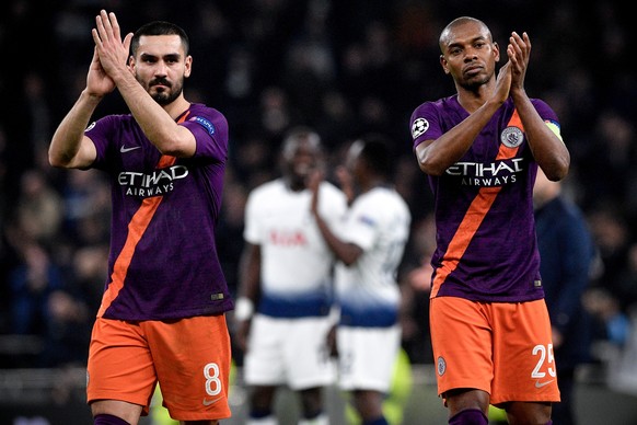 epa07495157 Manchester City players Ilkay Guendogan (L) and Fernandinho (R) react as Tottenham players (C) celebrate their win after the UEFA Champions League quarter final first leg soccer match betw ...