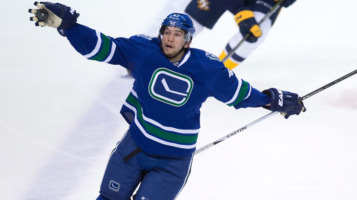 Vancouver Canucks' Sven Baertschi, of Switzerland, grabs the puck out of the air during second period NHL hockey action against the Nashville Predators in Vancouver, British Columbia, Tuesday, Ja ...