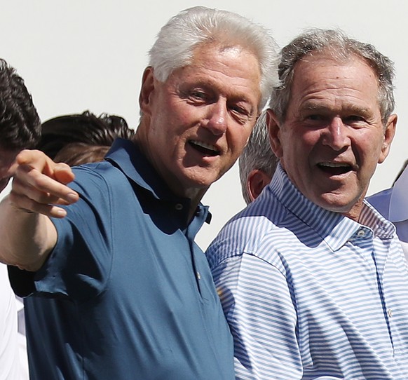 epa08859435 (FILE) - Former US Presidents Bill Clinton (L), George W. Bush (C) and Barack Obama during opening ceremonies for the 2017 Presidents Cup at Liberty National Golf Club in Jersey City, New  ...