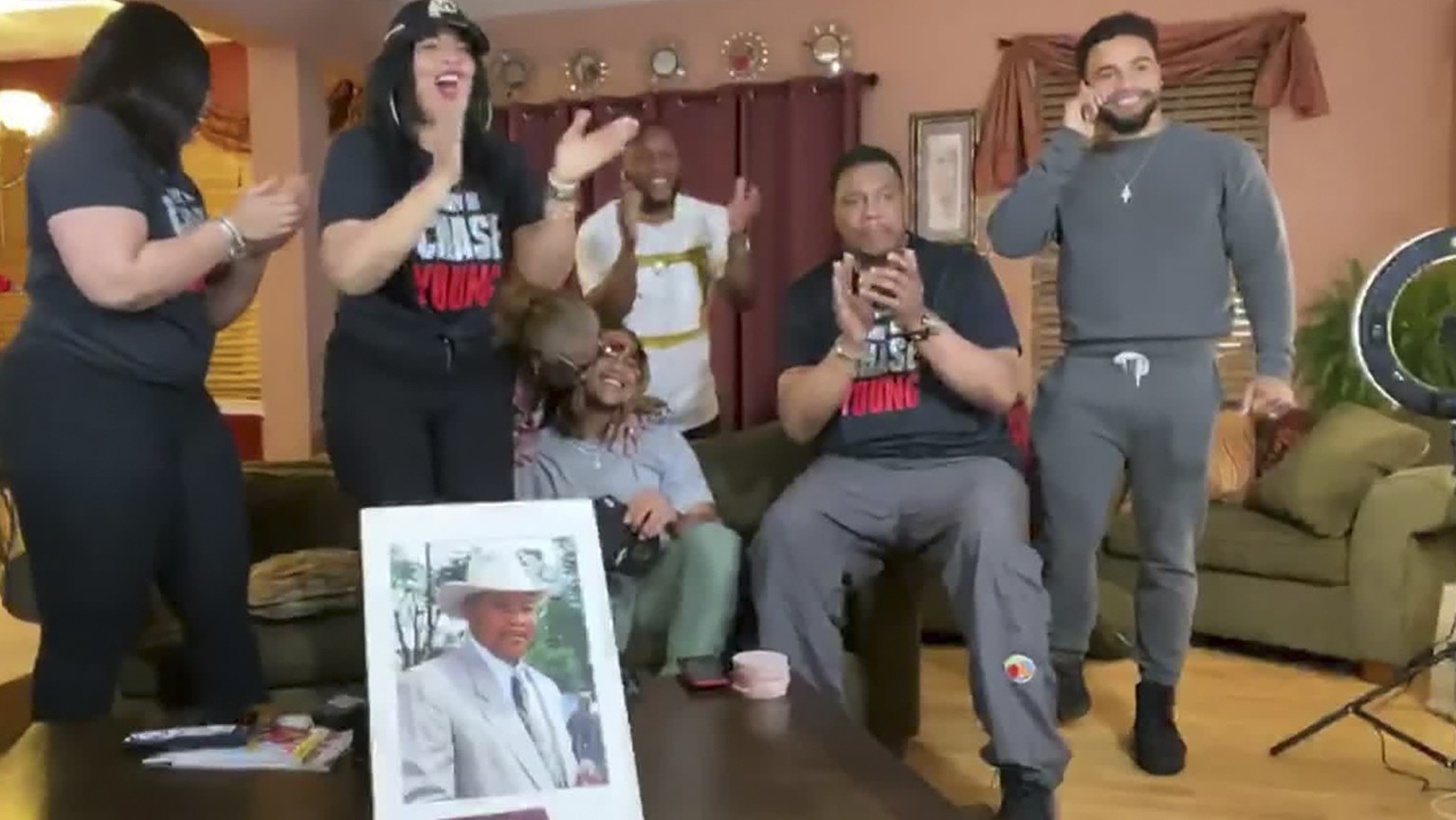 In this still image from video provided by the NFL, Chase Young, right, talks on his cellphone during the NFL football draft Thursday, April 23, 2020. (NFL via AP)
Chase Young