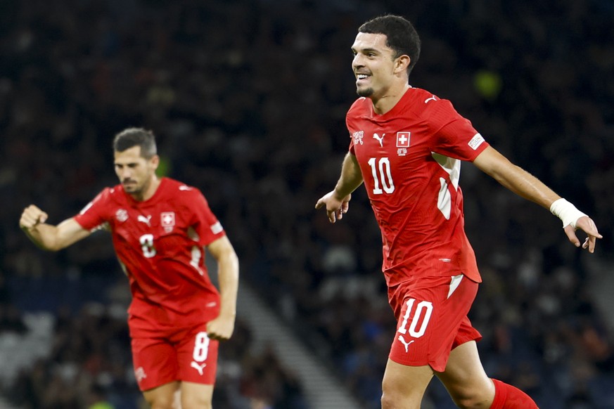 Switzerland's Zeki Amdouni, right, and Switzerland's Remo Freuler, left, celebrate the third goal during the UEFA Nations League soccer match between Scotland and Switzerland at the Hampden  ...