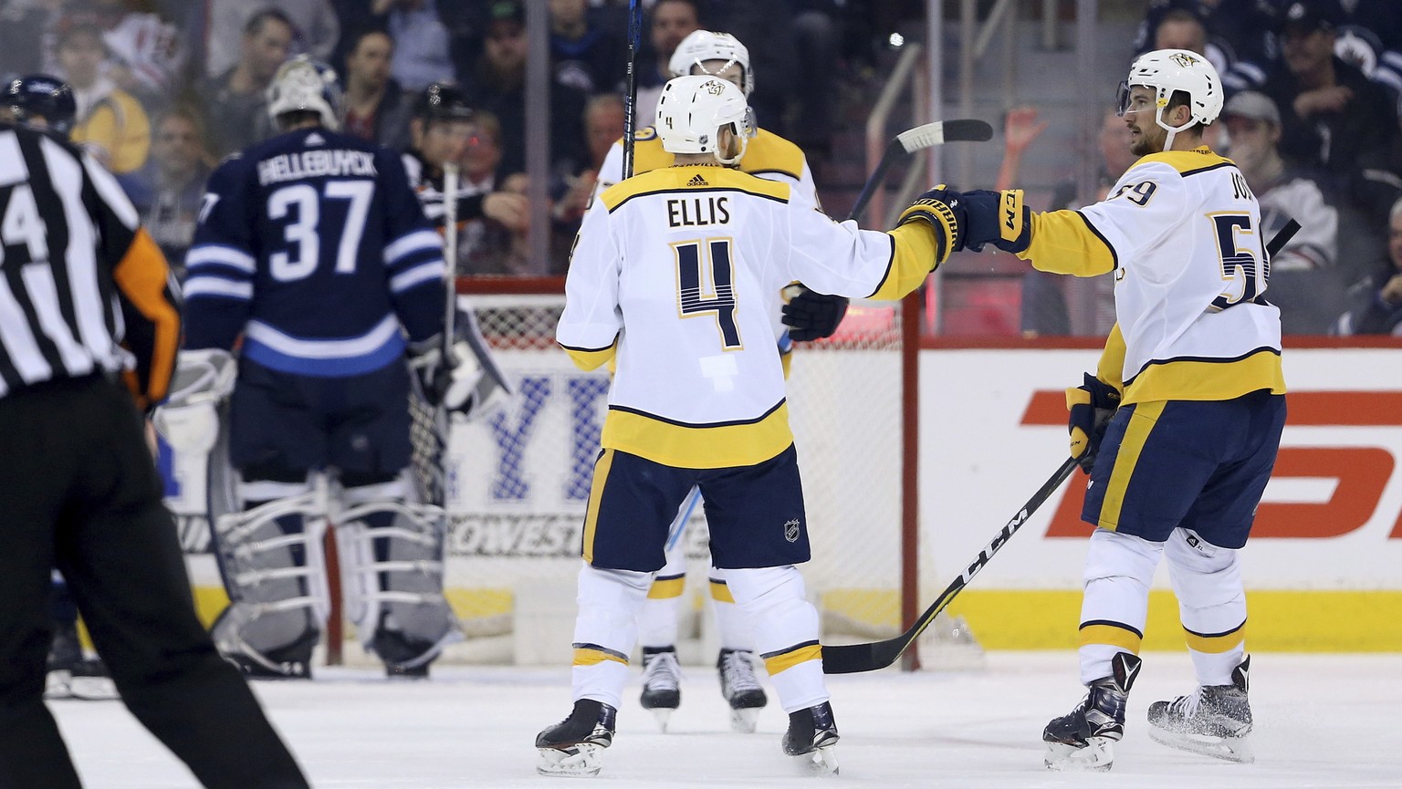 Nashville Predators&#039; Ryan Johansen (92), Ryan Ellis (4) and Roman Josi (59) celebrating after Josi scored on Winnipeg Jets&#039; goaltender Connor Hellebuyck (37) during first period NHL hockey a ...