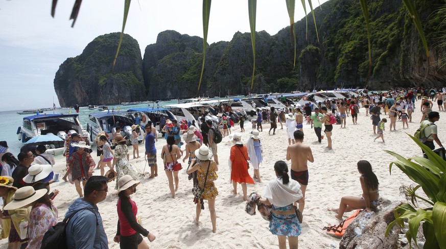 Tourists enjoy the beach on Maya Bay, Phi Phi Leh island in Krabi province, Thailand, Thursday, May 31, 2018. The popular tourist destination of Maya Bay in the Andaman Sea will close to tourists for  ...