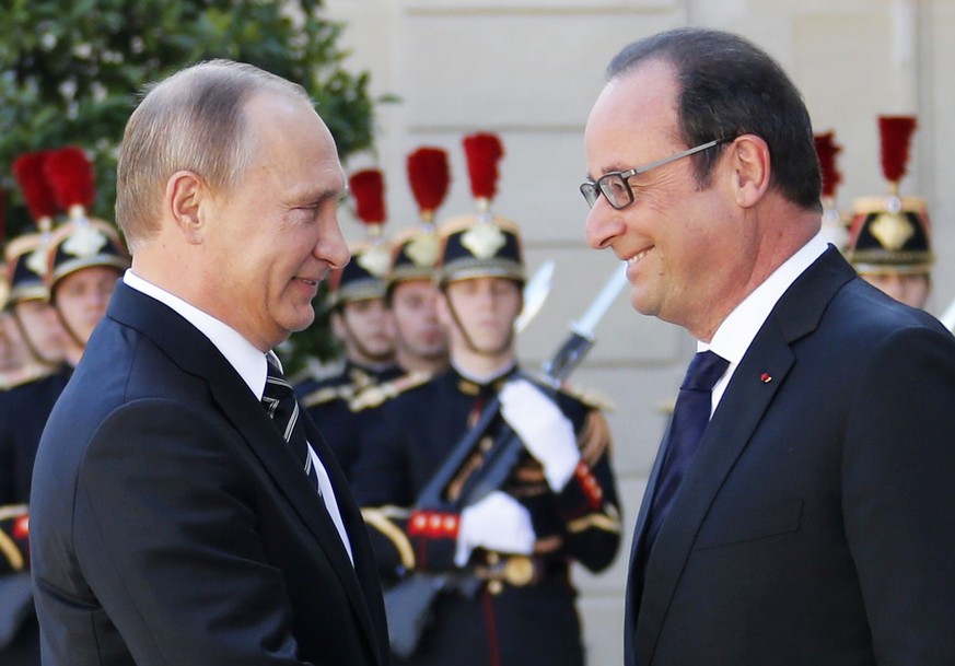 Dasselbe Lächeln, aber konträre Interessen: Assad-Freund Putin trifft Assad-Gegner Hollande.