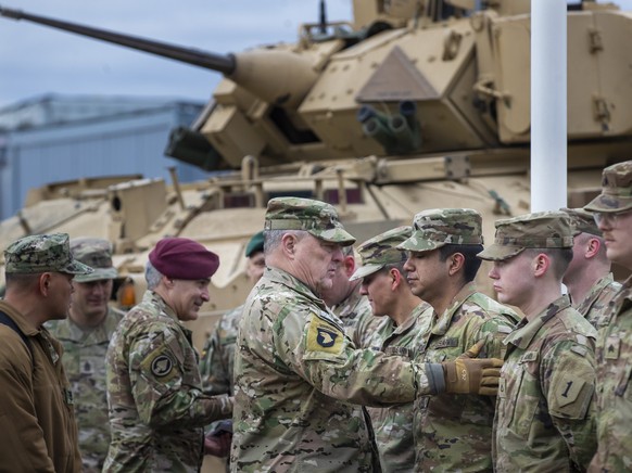 Chairman of the Joint Chiefs of Staff Gen. Mark Milley greets a soldiers of the U.S. Army, at the Training Range in Pabrade, some 60km.(38 miles) north of the capital Vilnius, Lithuania, Sunday, March ...