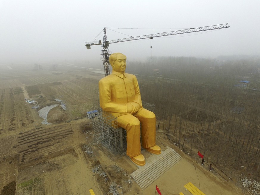 A crane is seen next to a giant statue of Chinese late chairman Mao Zedong under construction near crop fields in a village of Tongxu county, Henan province, China, January 4, 2016. REUTERS/Stringer/F ...